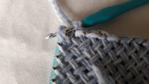 Make first stitch in corner C